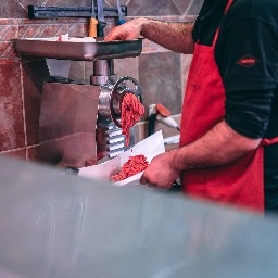 man grinding meat